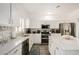 Modern kitchen with white cabinets, an island, and stainless steel appliances at 15006 N 172Nd Ln, Surprise, AZ 85388