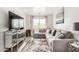 Comfortable living room featuring a large sectional sofa, modern TV console, and stylish decor at 15006 N 172Nd Ln, Surprise, AZ 85388