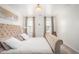 The main bedroom features a luxurious upholstered bed, soft lighting, and neutral decor at 15006 N 172Nd Ln, Surprise, AZ 85388