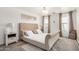 The main bedroom features a luxurious upholstered bed, soft lighting, and neutral decor at 15006 N 172Nd Ln, Surprise, AZ 85388