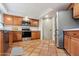 Kitchen featuring wood cabinets, white countertops, stainless steel appliances, and tiled floors at 16648 N 30Th Ave, Phoenix, AZ 85053