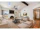 Bright living room featuring a brick fireplace, two skylights, beamed ceiling, and tiled flooring at 16648 N 30Th Ave, Phoenix, AZ 85053