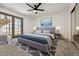 Beautiful bedroom featuring a ceiling fan, carpet, and a full glass door leading to the patio at 16648 N 30Th Ave, Phoenix, AZ 85053