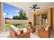 Inviting covered patio with comfortable wicker furniture and manicured artificial turf at 16648 N 30Th Ave, Phoenix, AZ 85053