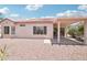 Backyard view of the home with covered patio and low maintenance desert landscaping at 20234 N Mariposa Way, Surprise, AZ 85374