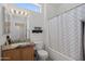 Bathroom with granite countertop, wood cabinet, and shower-tub combo at 20234 N Mariposa Way, Surprise, AZ 85374