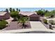 Charming single story home with low maintenance desert landscaping and mature shade tree at 20234 N Mariposa Way, Surprise, AZ 85374