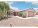 Charming single-story home features a well-kept landscape, desert flora, and a two-car garage at 20234 N Mariposa Way, Surprise, AZ 85374