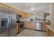 Well-lit kitchen features stainless steel appliances, granite countertops, and ample cabinet space at 20234 N Mariposa Way, Surprise, AZ 85374