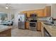 Bright kitchen features granite countertops, stainless steel appliances, and light wood cabinetry at 20234 N Mariposa Way, Surprise, AZ 85374