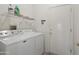 Convenient laundry room with washer, dryer, and overhead storage shelf at 20234 N Mariposa Way, Surprise, AZ 85374