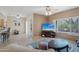 Open-concept living room featuring tile floors, ceiling fans, and seamless access to the kitchen at 20234 N Mariposa Way, Surprise, AZ 85374