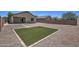 Great backyard space with low-maintenance landscaping with small patch of artificial grass at 20410 N Mac Neil St, Maricopa, AZ 85138