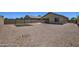 Expansive backyard with gravel and small artificial turf area, surrounded by block wall at 20410 N Mac Neil St, Maricopa, AZ 85138