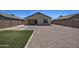 Gravel backyard with artificial turf, stepping stones, covered patio and block wall fence at 20410 N Mac Neil St, Maricopa, AZ 85138