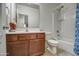 Bathroom with dark wood cabinets, tile floors, and a shower-tub combination at 20410 N Mac Neil St, Maricopa, AZ 85138