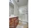 Bright bathroom features a glass-enclosed shower, wood vanity, and neutral finishes for a clean, modern look at 20410 N Mac Neil St, Maricopa, AZ 85138