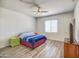 Well-lit bedroom featuring luxury vinyl plank floors, ceiling fan and walk-in closet at 20410 N Mac Neil St, Maricopa, AZ 85138