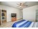 Main bedroom featuring ceiling fan, natural light, and en-suite access at 20410 N Mac Neil St, Maricopa, AZ 85138