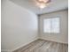 Well-lit bedroom featuring luxury vinyl plank floors, large window and ceiling fan at 20410 N Mac Neil St, Maricopa, AZ 85138