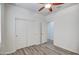Bright bedroom with wood-look flooring, ceiling fan and large closet at 20410 N Mac Neil St, Maricopa, AZ 85138