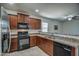 Stylish kitchen featuring modern appliances, granite countertops, and wood cabinetry at 20410 N Mac Neil St, Maricopa, AZ 85138
