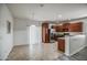 Open-concept kitchen featuring stainless-steel appliances, wood cabinets, and tile flooring in the breakfast nook at 20410 N Mac Neil St, Maricopa, AZ 85138