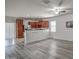Well-lit open-concept kitchen showcasing wood cabinetry, stainless steel appliances, and tile flooring at 20410 N Mac Neil St, Maricopa, AZ 85138
