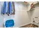 Spacious walk-in closet with clothes hanging on the rod and a storage shelf at 20410 N Mac Neil St, Maricopa, AZ 85138