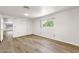 Spacious bedroom features wood-look floors, a window, and closet with sliding doors at 2650 W Union Hills Dr # 215, Phoenix, AZ 85027