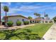 Community clubhouse with green lawn, attractive landscaping, and an American flag at 2650 W Union Hills Dr # 215, Phoenix, AZ 85027