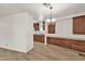 Bright dining area featuring wood floors, built-in cabinets, and stylish lighting fixture at 2650 W Union Hills Dr # 215, Phoenix, AZ 85027