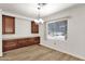 Dining area featuring built-in cabinets, stylish chandelier, and natural light at 2650 W Union Hills Dr # 215, Phoenix, AZ 85027