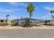 Inviting single-story residence with covered carport, accented by palm trees and desert landscaping at 2650 W Union Hills Dr # 215, Phoenix, AZ 85027