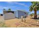 Exterior of the home with gravel landscaping, palm tree, and storage shed at 2650 W Union Hills Dr # 215, Phoenix, AZ 85027