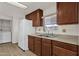 Functional kitchen with wood cabinets, updated appliances, and ample counter space at 2650 W Union Hills Dr # 215, Phoenix, AZ 85027