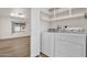 Convenient laundry room with modern washer and dryer, and ample shelving at 2650 W Union Hills Dr # 215, Phoenix, AZ 85027