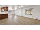 Bright living room featuring wood floors that connect to kitchen and other spaces at 2650 W Union Hills Dr # 215, Phoenix, AZ 85027