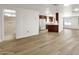 Open-concept living room with wood floors connecting the kitchen and bathroom at 2650 W Union Hills Dr # 215, Phoenix, AZ 85027
