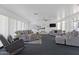 Community lounge with comfortable seating, a television, and views into the kitchen at 2650 W Union Hills Dr # 215, Phoenix, AZ 85027