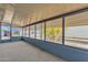 Cozy enclosed porch featuring numerous windows, carpeting, and a sliding glass door at 2650 W Union Hills Dr # 215, Phoenix, AZ 85027