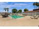 Sparkling swimming pool with lounge chairs, umbrellas, and lush landscaping at 2650 W Union Hills Dr # 215, Phoenix, AZ 85027