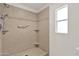 Walk-in shower with neutral tiling, a grab bar, and a built-in corner shelf at 2650 W Union Hills Dr # 215, Phoenix, AZ 85027