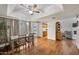 Wide shot of dining room with wood floors, ceiling fan, and access to kitchen and bedrooms at 2929 E Broadway Rd # 50, Mesa, AZ 85204
