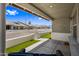 Beautiful street view from a covered front porch with white brick wall and artificial turf at 2929 E Broadway Rd # 50, Mesa, AZ 85204