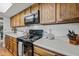 Close up of kitchen featuring black appliances, wood cabinets, and light countertops at 2929 E Broadway Rd # 50, Mesa, AZ 85204