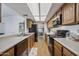 Open kitchen boasts wood cabinets, light counters, stainless appliances, and breakfast bar at 2929 E Broadway Rd # 50, Mesa, AZ 85204
