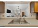 Kitchen sink overlooks living room with a neutral palette and bright natural lighting at 2929 E Broadway Rd # 50, Mesa, AZ 85204