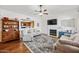 Spacious living room with hardwood floors, fireplace, and view of the kitchen in the background at 2929 E Broadway Rd # 50, Mesa, AZ 85204