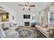 Bright living room with large fireplace, ceiling fan, and two large sofas at 2929 E Broadway Rd # 50, Mesa, AZ 85204